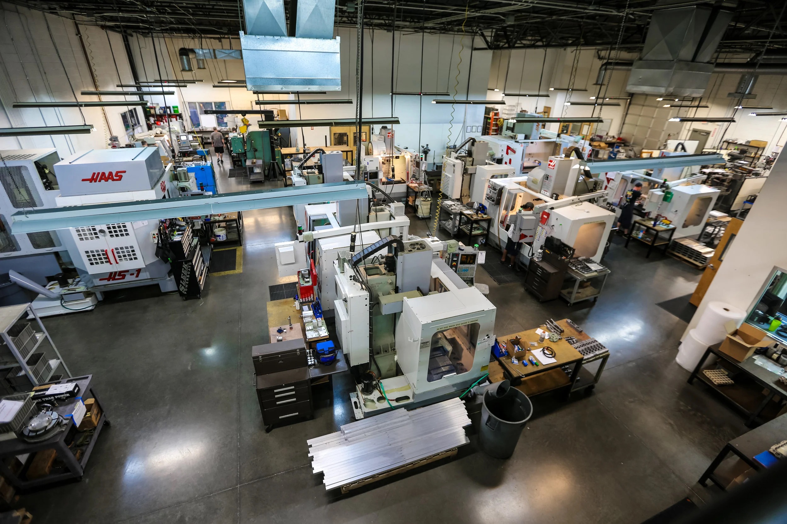CNC machine shop floor — rows of Haas vertical and horizontal mills